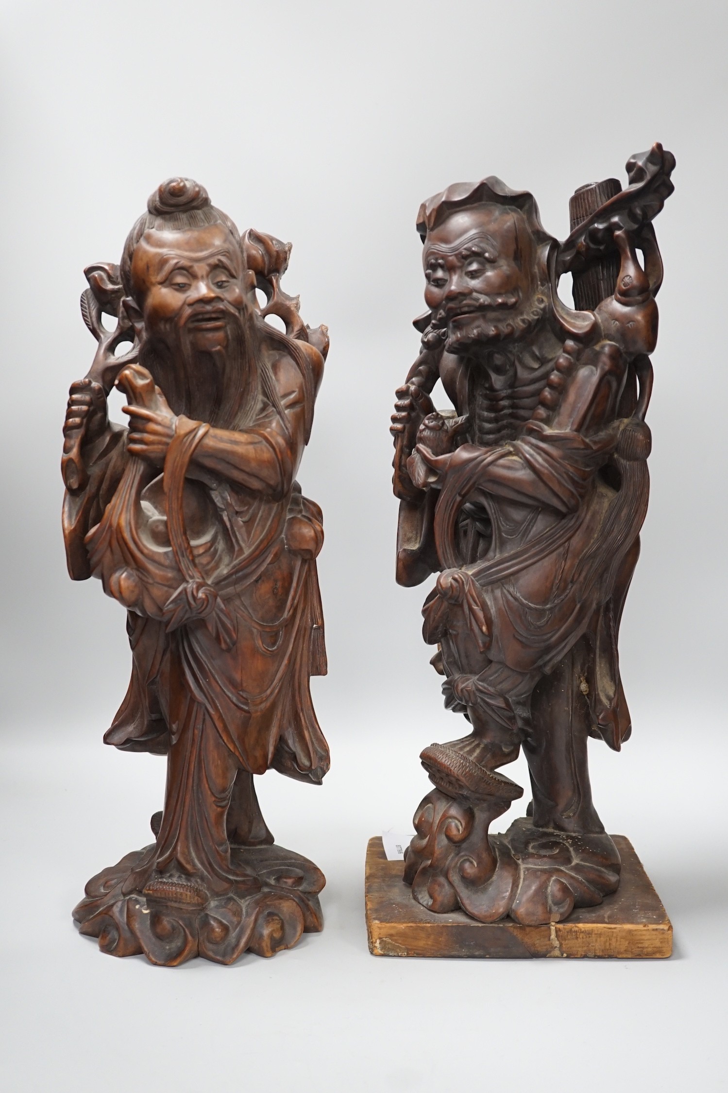 Two Chinese hardwood figures of luohans, early 20th century Tallest 48cm